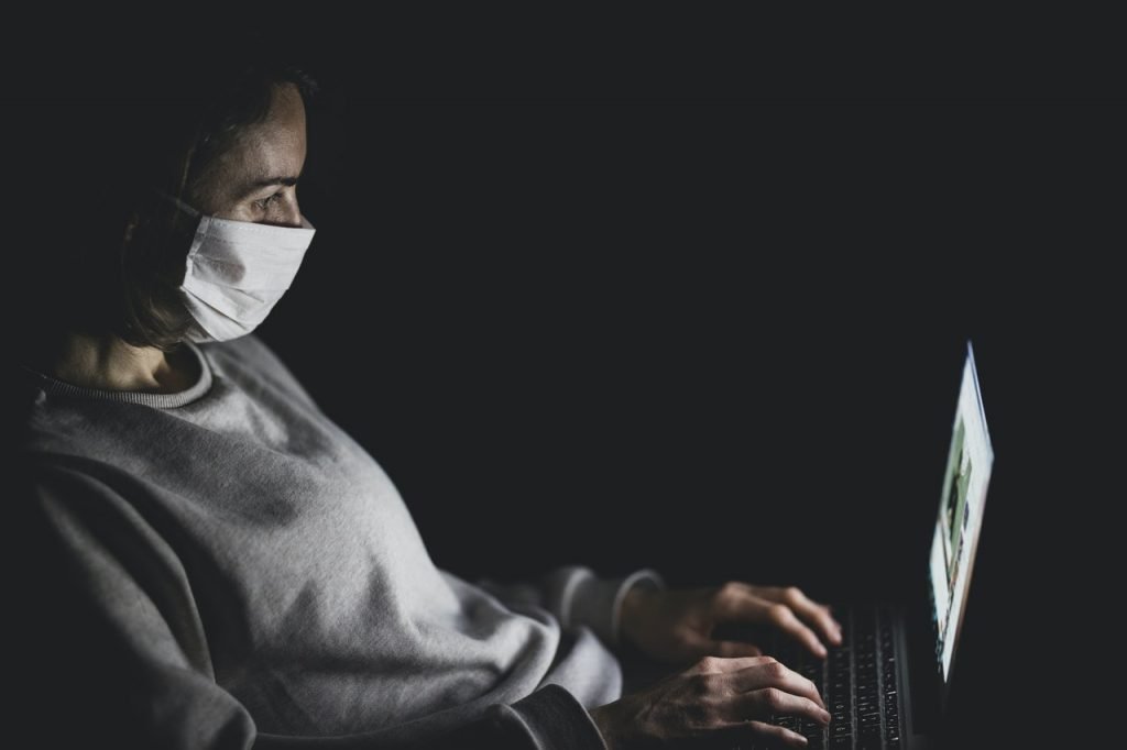 Woman Wearing Face Mask Using Black Laptop Computer 4031905